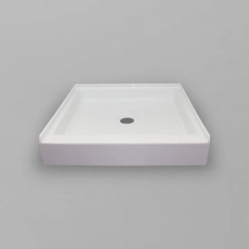 White Acritec regular profile single threshold shower base with center drain in a standard alcove shower setup