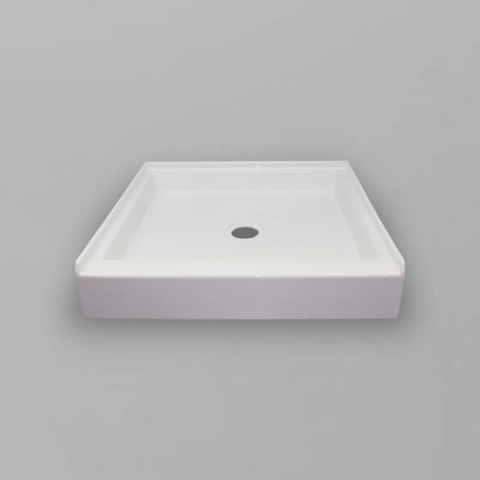 White Acritec regular profile single threshold shower base with center drain in a standard alcove shower setup