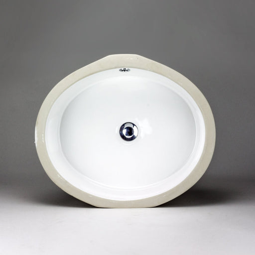White oval Acritec undermount ceramic basin with flat bottom installed under a chic countertop