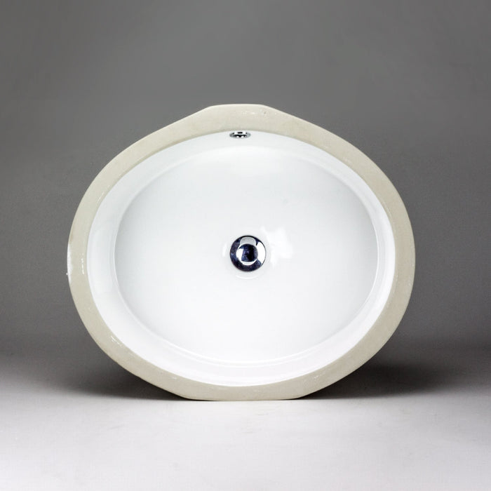 White oval Acritec undermount ceramic basin with flat bottom installed under a chic countertop