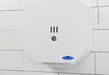 Frost 168 white steel double jumbo toilet tissue dispenser in use