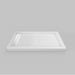 White Acritec linear end drain low profile double threshold shower base with LH stainless grill in an industrial bathroom
