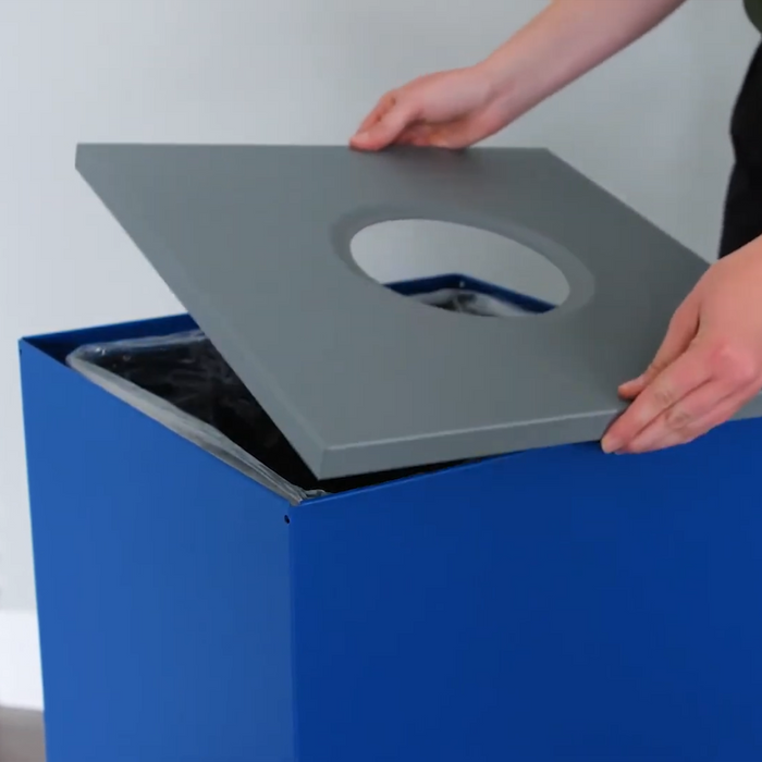 Close-up of embossed Mixed Recyclables slot on blue lid