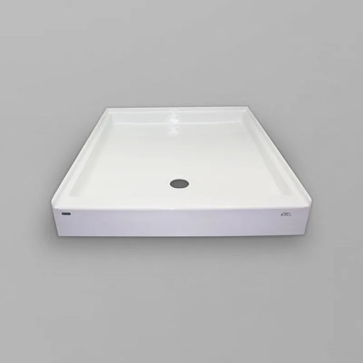 White Acritec regular profile single threshold shower base with end drain in a standard alcove shower setup